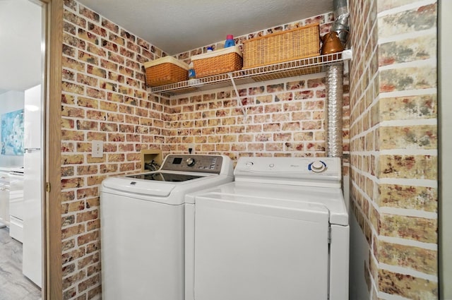 2675 Pine Marsh Dr, Grove City, OH 43123 - clothes washing area with separate washer and dryer and brick wall