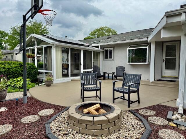 3145 Bembridge Rd, Columbus, OH 43221 - view of patio / terrace featuring a sunroom and an outdoor fire pit