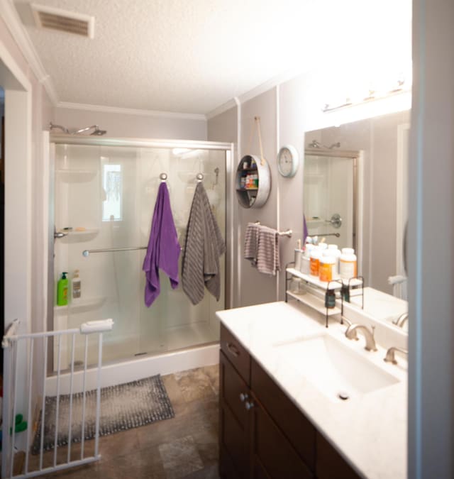 25 Ravine Ridge Dr, Delaware, OH 43015 - bathroom with vanity, crown molding, a stall shower, and a textured ceiling
