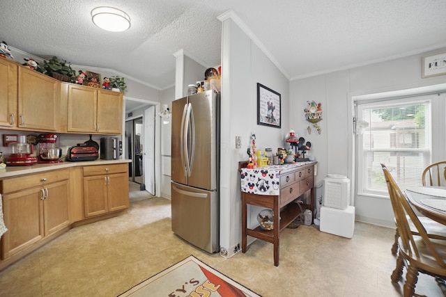 25 Ravine Ridge Dr, Delaware, OH 43015 - kitchen featuring freestanding refrigerator, light countertops, crown molding, vaulted ceiling, and a textured ceiling