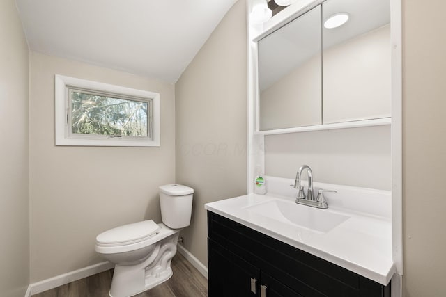 624 Bendle Ave, Shelby, OH 44875 - half bath with wood finished floors, toilet, baseboards, vanity, and vaulted ceiling