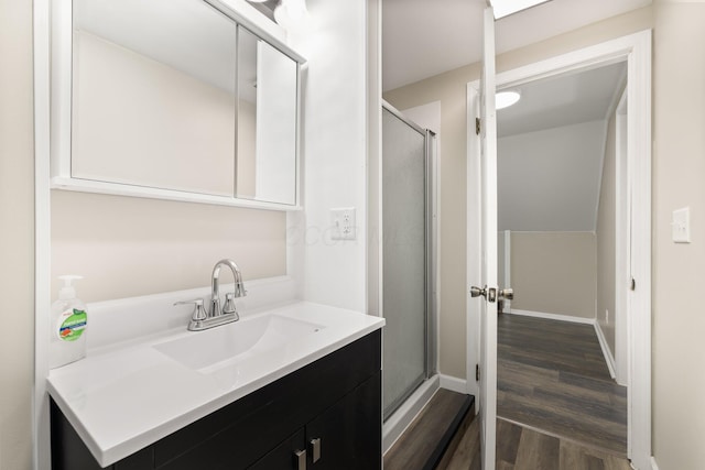 624 Bendle Ave, Shelby, OH 44875 - full bathroom with wood finished floors, a shower stall, vanity, and baseboards