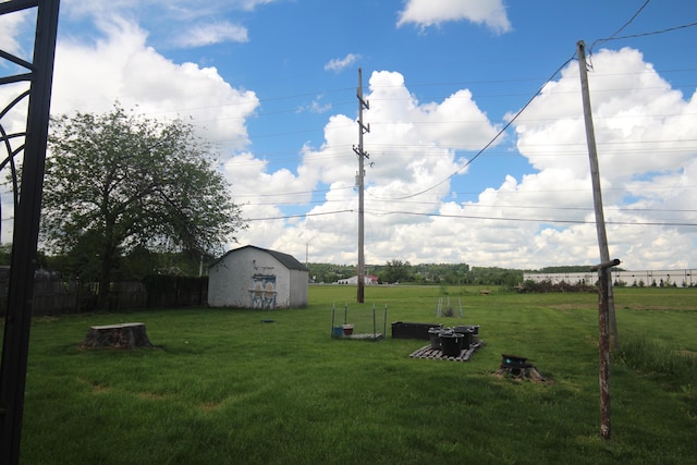 view of yard with a storage shed and an outdoor structure