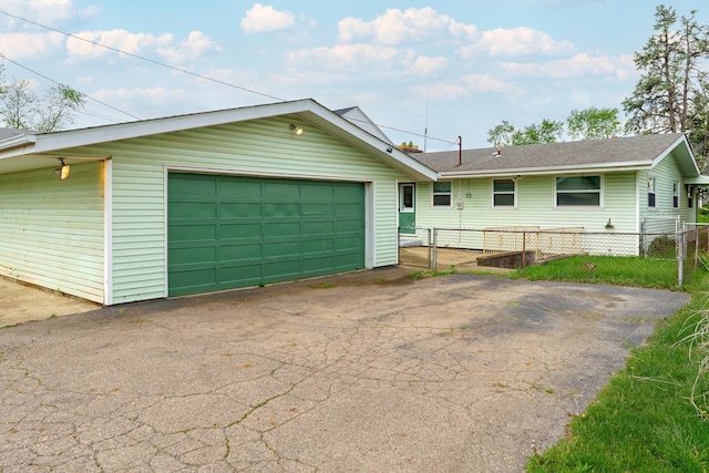 view of front of home featuring a garage and fence