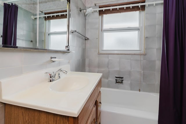 full bath with healthy amount of natural light, shower / bath combo with shower curtain, and vanity
