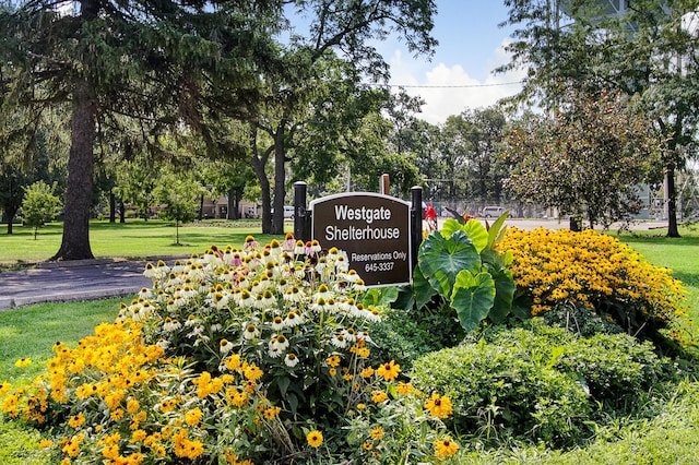 community sign featuring a lawn