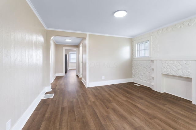 774 Congress St, Marion, OH 43302 - unfurnished living room with healthy amount of natural light, ornamental molding, wood finished floors, arched walkways, and baseboards