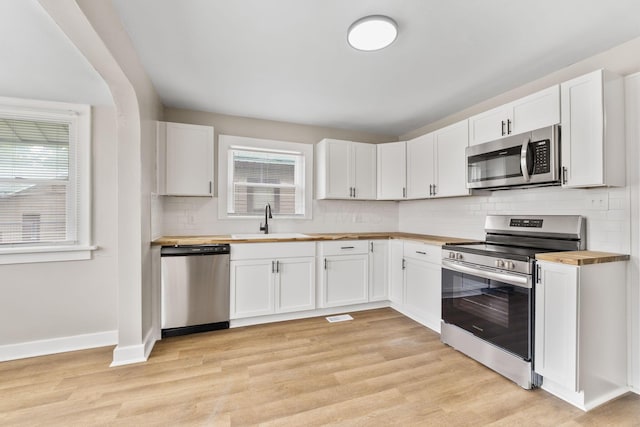 774 Congress St, Marion, OH 43302 - kitchen featuring appliances with stainless steel finishes, butcher block countertops, a sink, and healthy amount of natural light