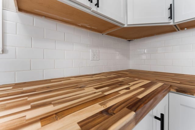 774 Congress St, Marion, OH 43302 - kitchen view of butcher block counters, decorative backsplash, and white cabinetry
