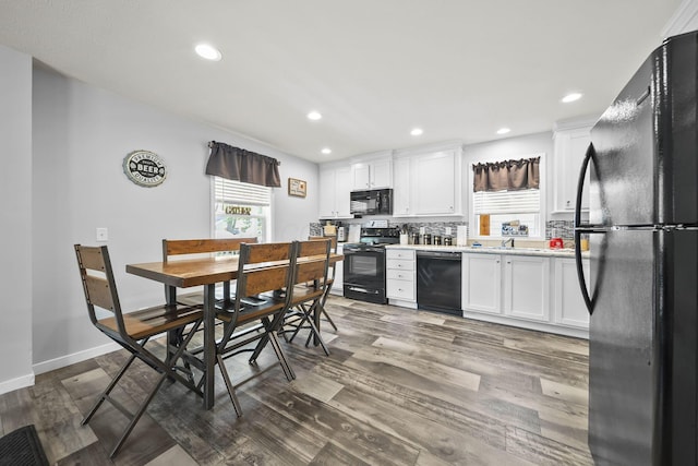 157 Joy Ave, Delaware, OH 43015 - kitchen with black appliances, light countertops, wood finished floors, white cabinets, and recessed lighting
