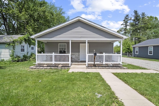 157 Joy Ave, Delaware, OH 43015 - bungalow-style home featuring a porch, a front yard, and gravel driveway