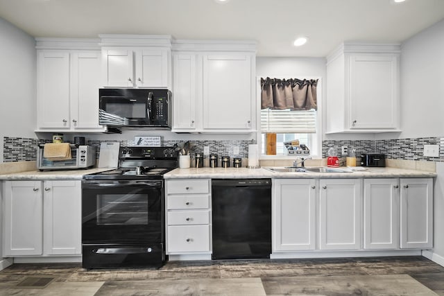 157 Joy Ave, Delaware, OH 43015 - kitchen with black appliances, a sink, decorative backsplash, white cabinets, and recessed lighting