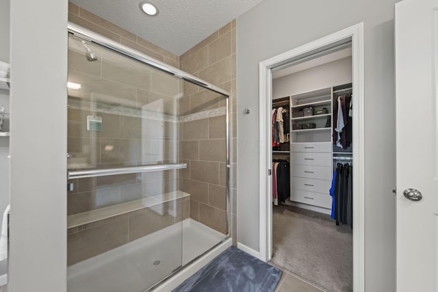 1070 Little Bear Pl, Lewis Center, OH 43035 - full bathroom with a shower stall, a spacious closet, and a textured ceiling