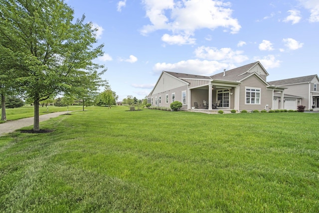 1070 Little Bear Pl, Lewis Center, OH 43035 - view of green lawn with an attached garage and a patio