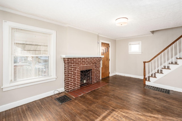 unfurnished living room featuring wood finished floors, baseboards, ornamental molding, a fireplace, and stairs