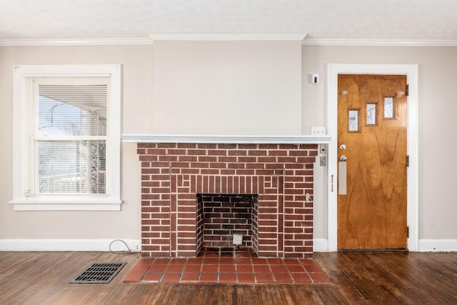 detailed view of wood finished floors, baseboards, a fireplace, a textured ceiling, and ornamental molding