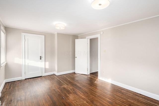 unfurnished room with crown molding, baseboards, and hardwood / wood-style floors