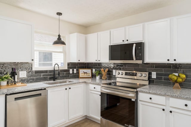 1993 Cumberland St, Newark, OH 43055 - kitchen featuring stainless steel appliances, a sink, white cabinets, and tasteful backsplash