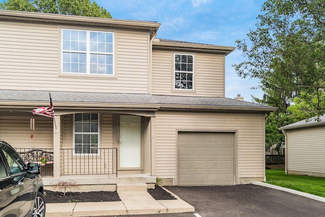 1810 Messner Dr Unit 62E, Hilliard, OH 43026 - view of front of home featuring covered porch, a garage, and driveway