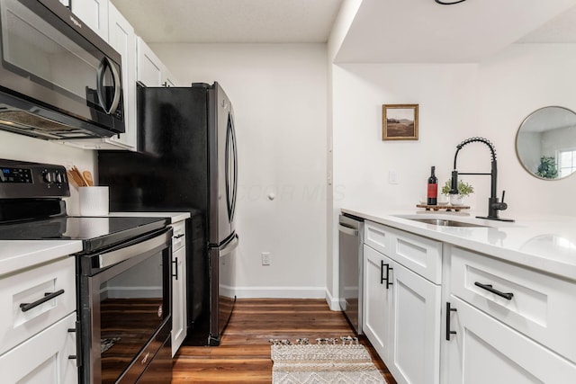 1810 Messner Dr Unit 62E, Hilliard, OH 43026 - kitchen with appliances with stainless steel finishes, white cabinetry, light countertops, dark wood-style floors, and a sink