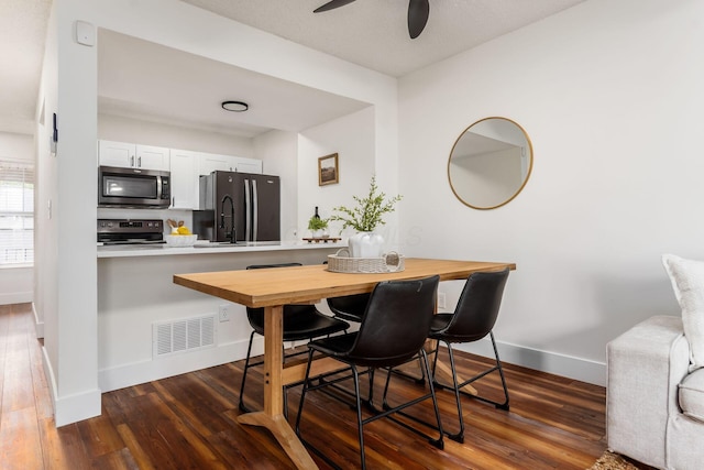 1810 Messner Dr Unit 62E, Hilliard, OH 43026 - dining area featuring baseboards, ceiling fan, and dark wood-style flooring