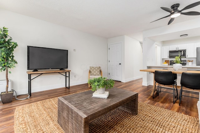 1810 Messner Dr Unit 62E, Hilliard, OH 43026 - living room with dark wood-style floors, a ceiling fan, and baseboards