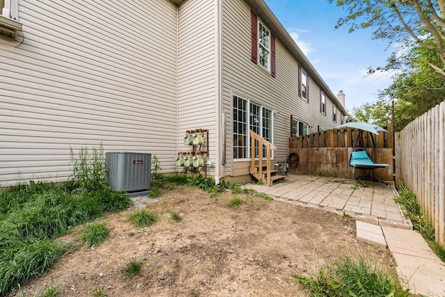 1810 Messner Dr Unit 62E, Hilliard, OH 43026 - back of house featuring cooling unit, a fenced backyard, a patio area, and entry steps