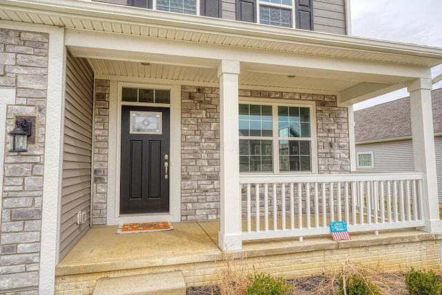 596 Courtright Dr E, Pickerington, OH 43147 - doorway to property featuring stone siding and a porch