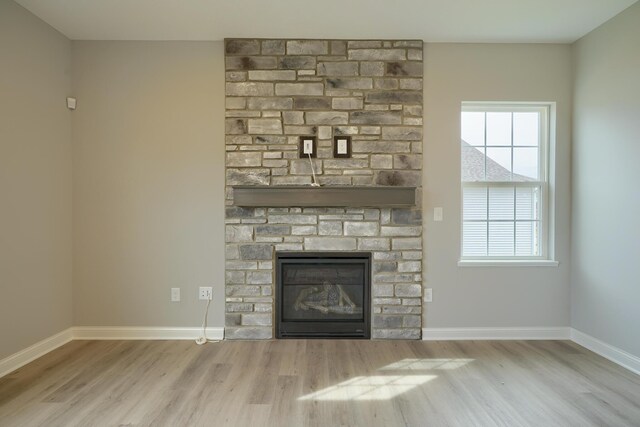 596 Courtright Dr E, Pickerington, OH 43147 - unfurnished living room featuring wood finished floors, a fireplace, and baseboards