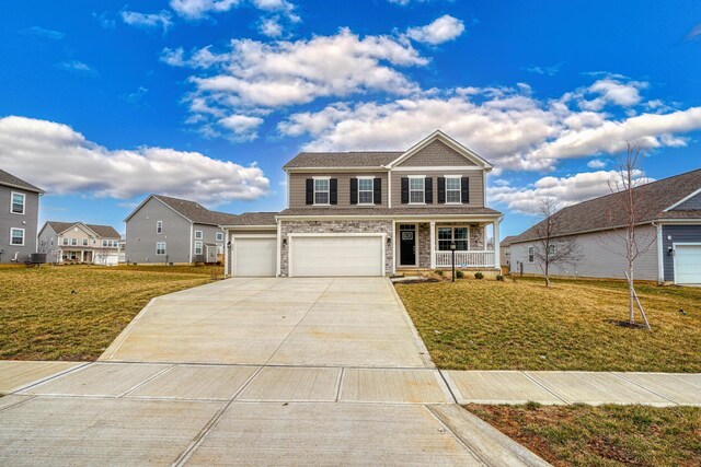 596 Courtright Dr E, Pickerington, OH 43147 - view of front facade with a porch, concrete driveway, a front lawn, and a garage