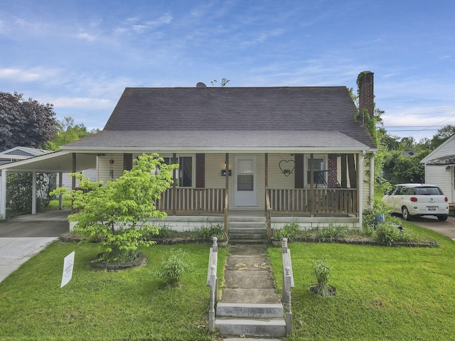 view of front of house featuring covered porch, a front lawn, a chimney, and a carport
