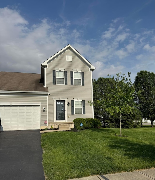 16 Hawthorne Dr, Ashville, OH 43103 - traditional-style home featuring asphalt driveway, a front yard, and a garage
