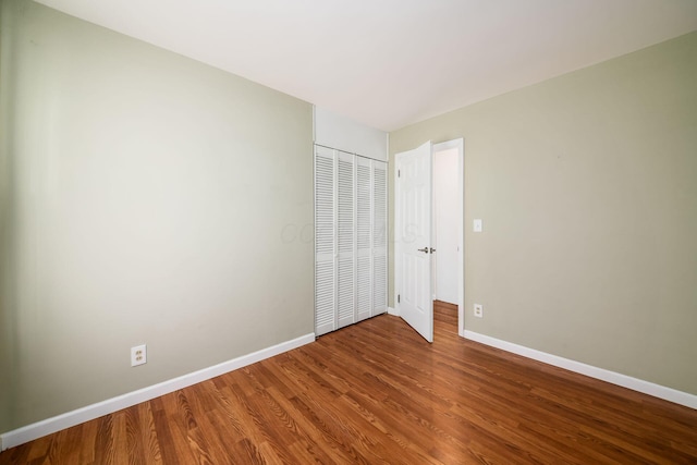 1512 Shanley Dr, Columbus, OH 43224 - unfurnished bedroom with baseboards, wood finished floors, and a closet