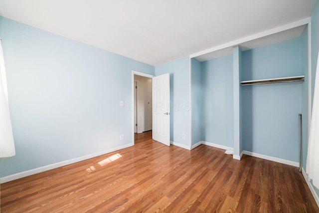 1512 Shanley Dr, Columbus, OH 43224 - unfurnished bedroom with wood finished floors, baseboards, and a closet