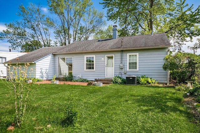 1512 Shanley Dr, Columbus, OH 43224 - rear view of house featuring a yard, entry steps, a chimney, and central AC