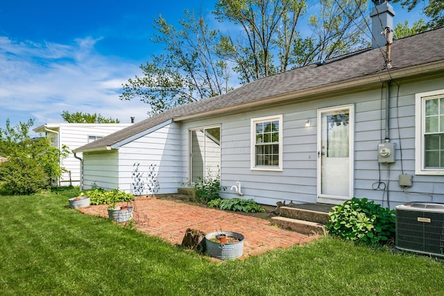 1512 Shanley Dr, Columbus, OH 43224 - rear view of property featuring central air condition unit, a yard, a patio area, and roof with shingles