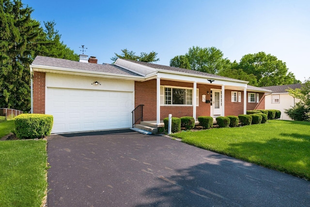 738 Stinson Dr, Columbus, OH 43214 - single story home featuring brick siding, asphalt driveway, a chimney, and a front yard