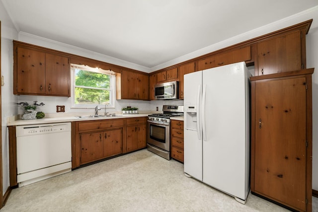 738 Stinson Dr, Columbus, OH 43214 - kitchen featuring stainless steel appliances, light countertops, and brown cabinetry