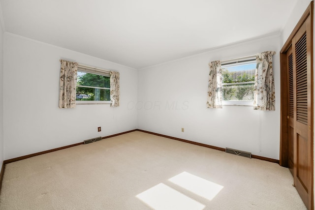 738 Stinson Dr, Columbus, OH 43214 - unfurnished bedroom featuring a closet, carpet, and ornamental molding