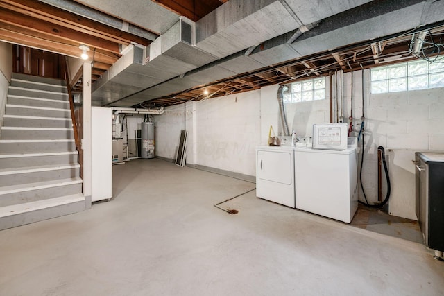 738 Stinson Dr, Columbus, OH 43214 - basement featuring separate washer and dryer, gas water heater, and stairway