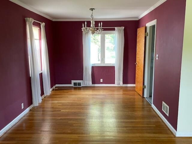 635 E Dominion Blvd, Columbus, OH 43214 - unfurnished dining area featuring a chandelier, wood finished floors, crown molding, and baseboards