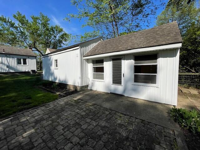 635 E Dominion Blvd, Columbus, OH 43214 - back of house with a patio area, a lawn, and a shingled roof