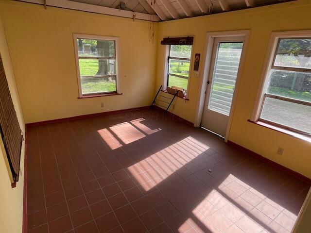 635 E Dominion Blvd, Columbus, OH 43214 - spare room with dark tile patterned flooring, baseboards, and wood ceiling