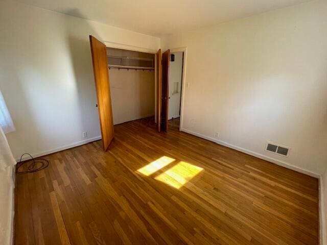 635 E Dominion Blvd, Columbus, OH 43214 - unfurnished bedroom with wood finished floors, a closet, and baseboards