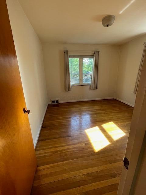 635 E Dominion Blvd, Columbus, OH 43214 - spare room with wood finished floors and baseboards