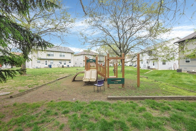 view of jungle gym featuring a lawn and a residential view