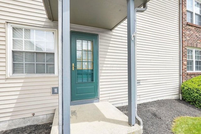 property entrance featuring brick siding