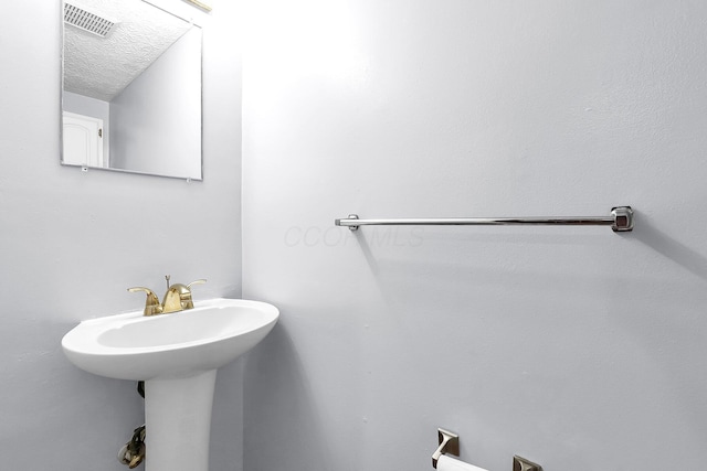 bathroom featuring a textured ceiling