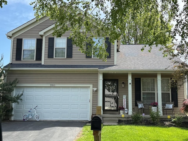 view of front facade with a porch, a garage, driveway, and a shingled roof
