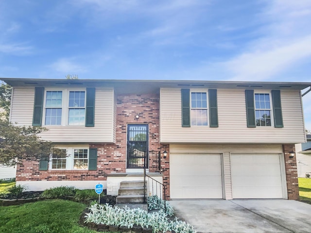 2620 Trailwind St, Grove City, OH 43123 - raised ranch with brick siding, an attached garage, and driveway
